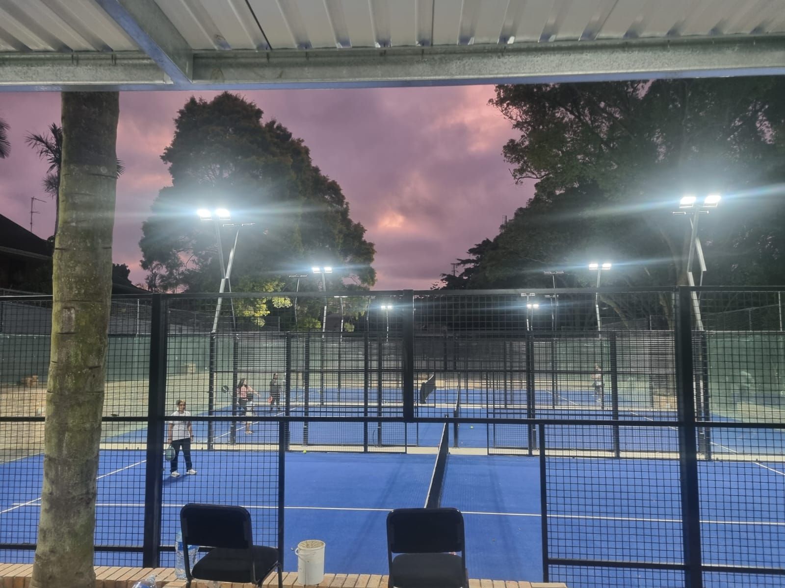 Sunset sky over the covered courtside deck at Westville Padel Club
